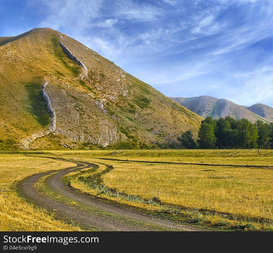 The Landscape with meanderring tape of the road in foothill South Ural. The Landscape with meanderring tape of the road in foothill South Ural.