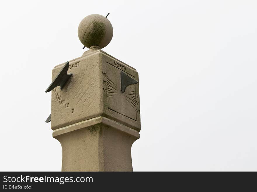 Old, mossy and worn, stone sun dial, a weatherworn symbol of time, weather, and travel; location is the state of Massachusetts, USA;. Old, mossy and worn, stone sun dial, a weatherworn symbol of time, weather, and travel; location is the state of Massachusetts, USA;