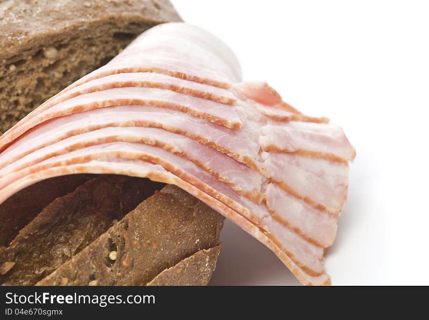 Raw bacon with bread over white background