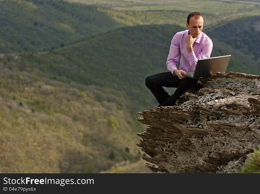 Man with notebook on stone