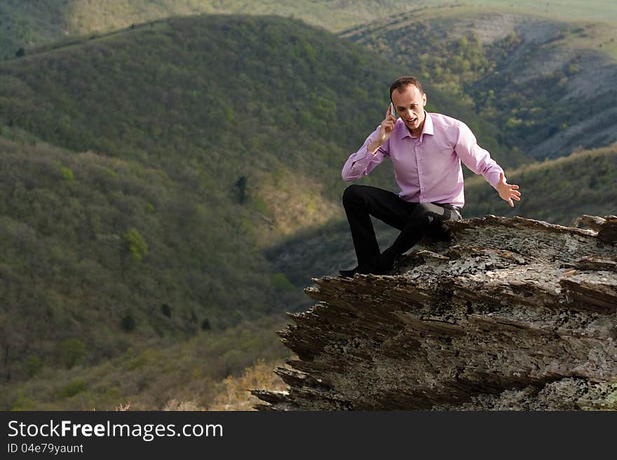 Man in mountain talks the telephone. Man in mountain talks the telephone