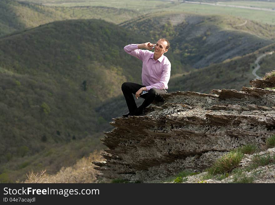 Man With Notepad And Telephone On Mountain