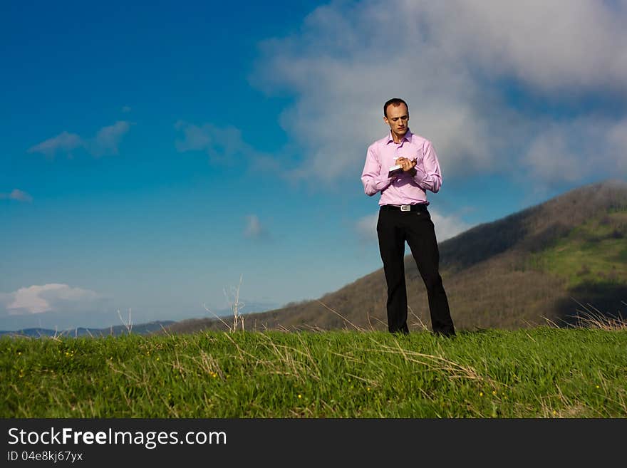 Man With Notepad On Mountain