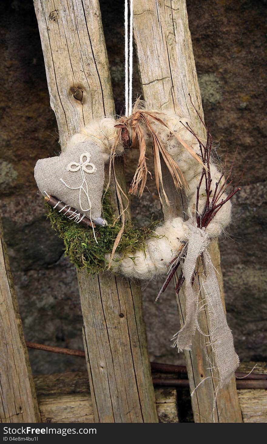 My handmade wreath on the door with natural materials: twigs, sticks, moss, linen, sheep wool