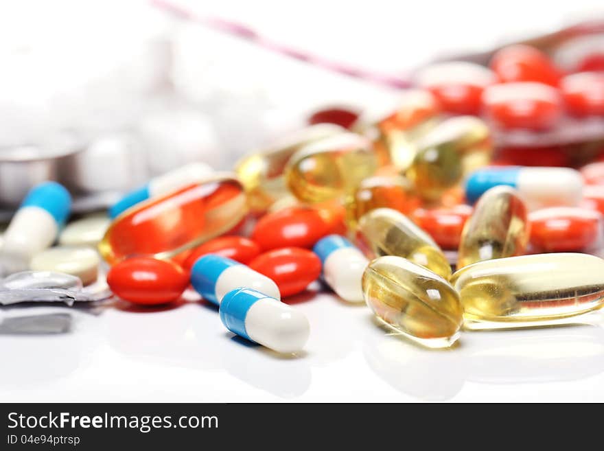 Close up of pills over white background