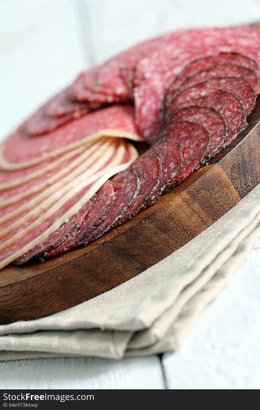 Fresh and delicious salami over wooden surface