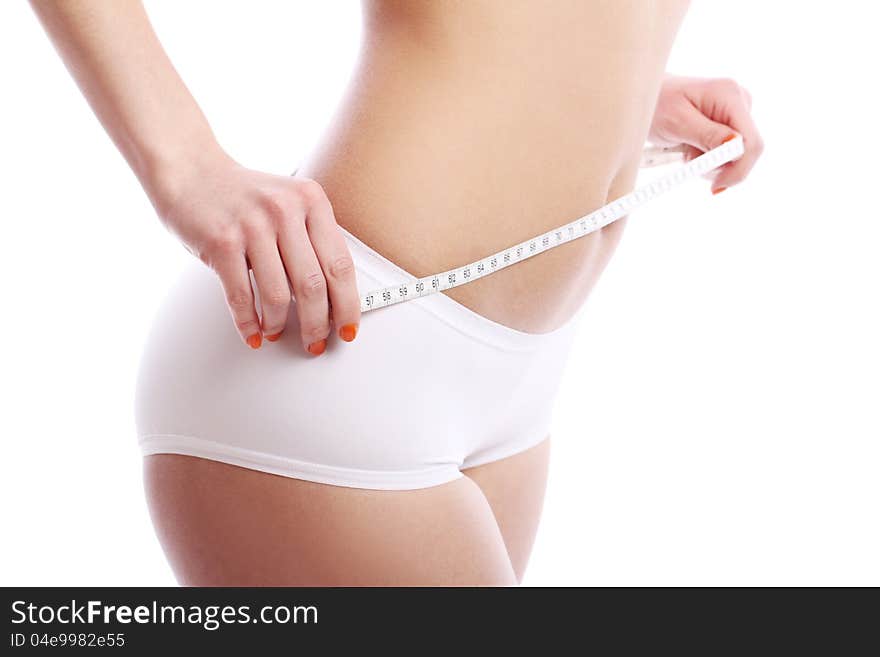 Woman with measuring tape over white background