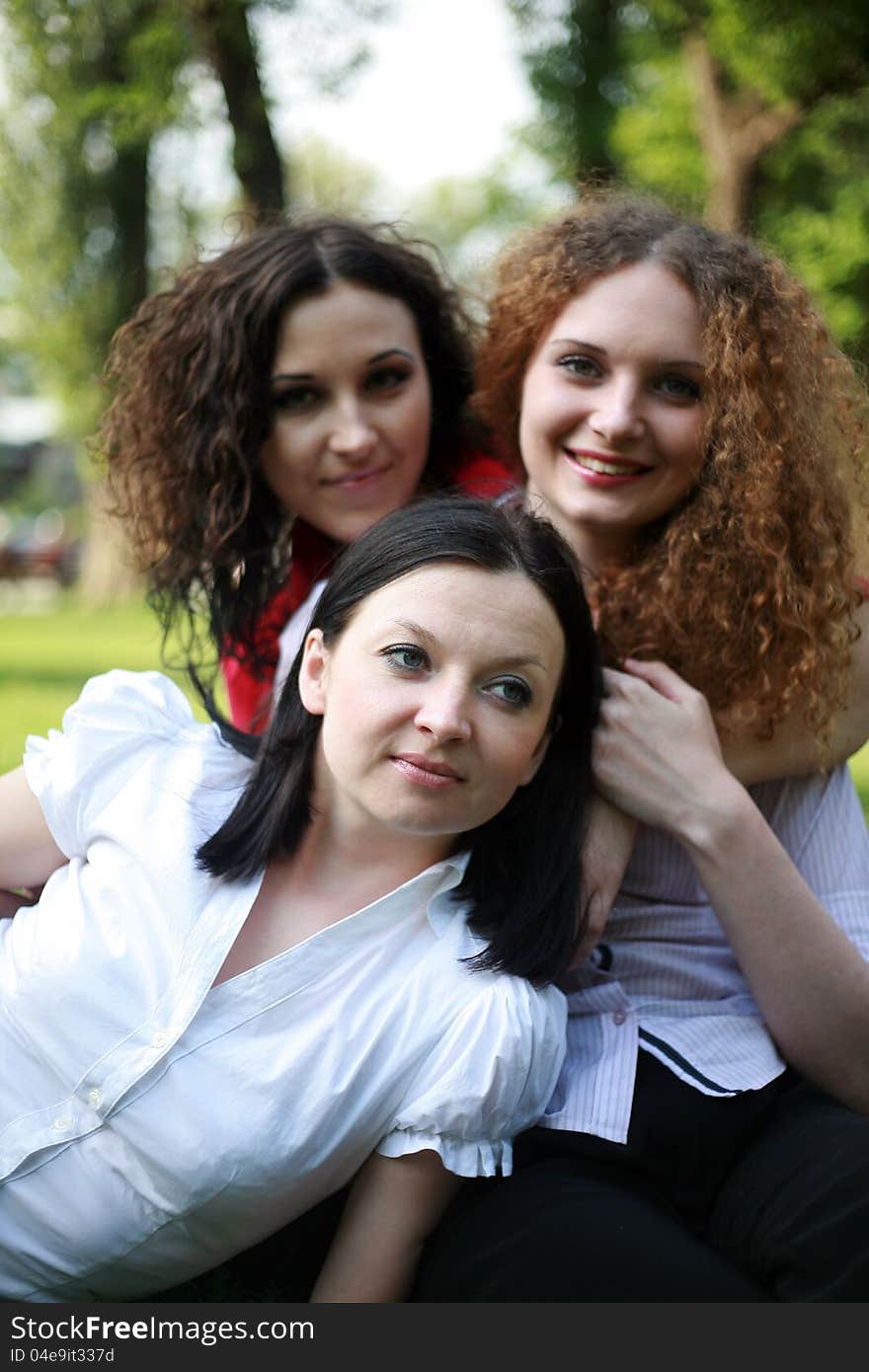 Portrait Of Three Girls Posing In The Park