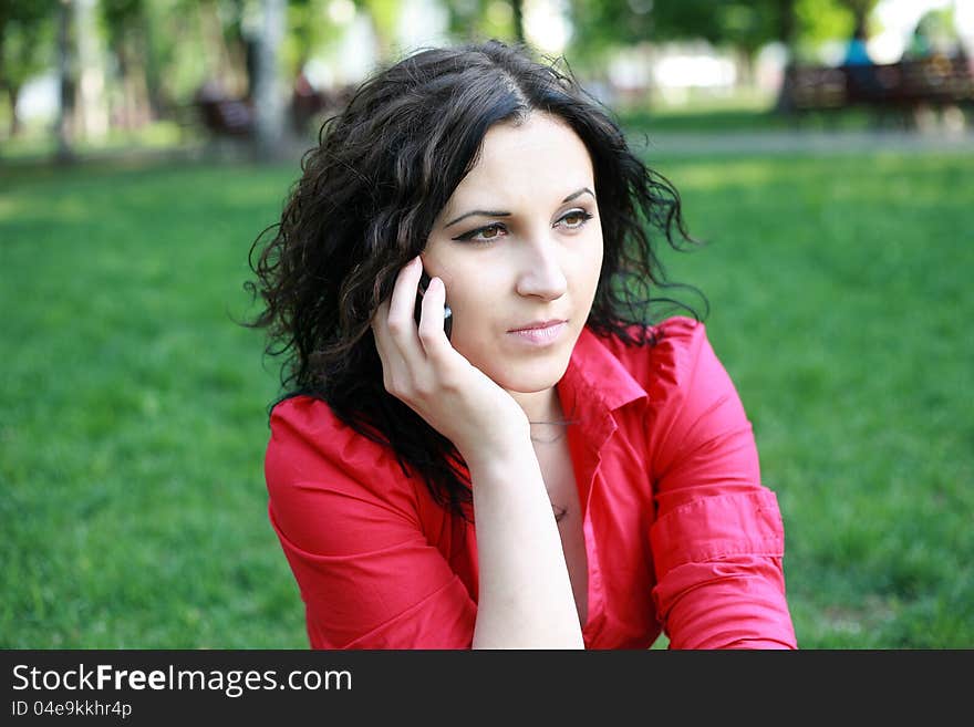 Portrait of a girl in a red shirt with the phone