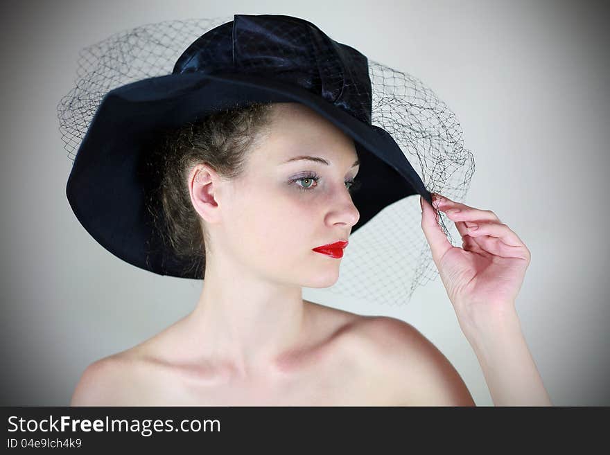 Glamorous portrait of a girl in retro hat