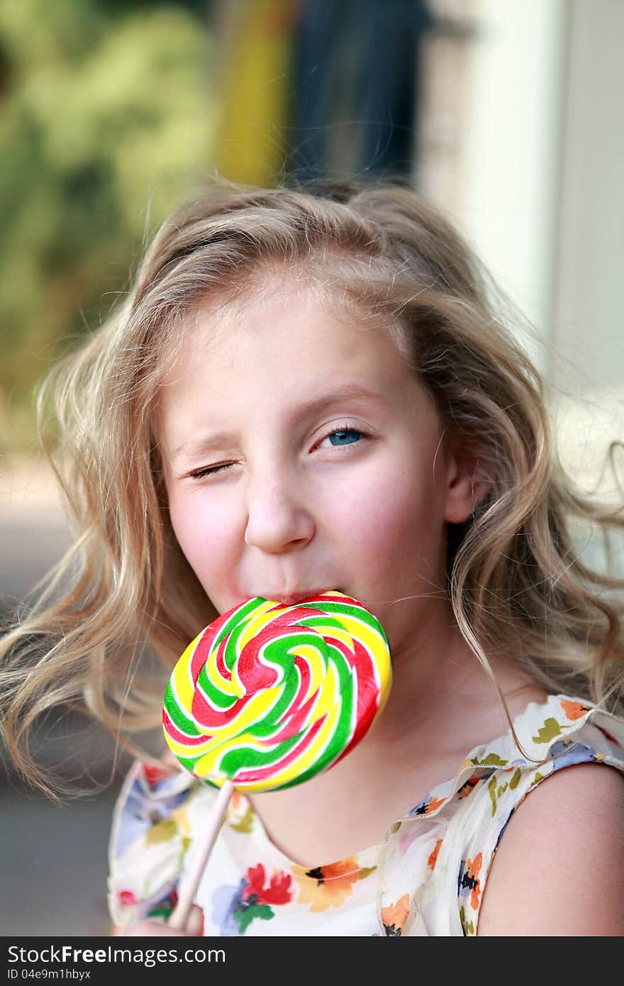 Portrait of a girl with a big candy