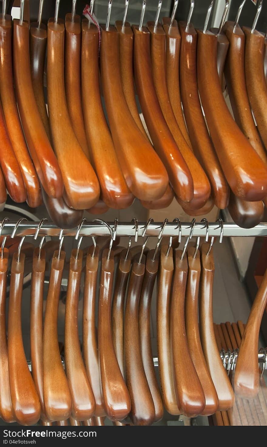 Many wood coat hanger on tube. Many wood coat hanger on tube