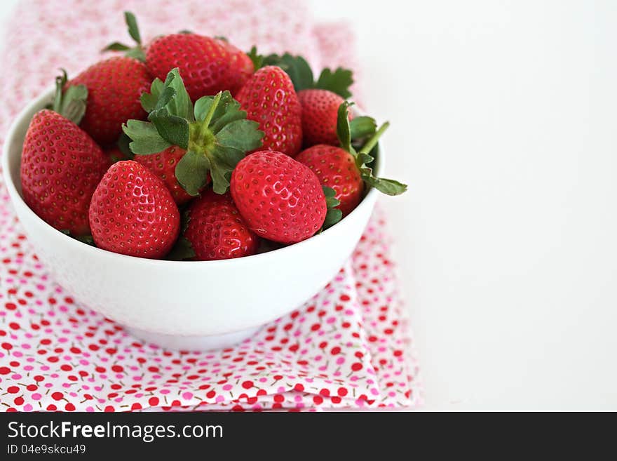 Strawberries in a white bowl with space for text