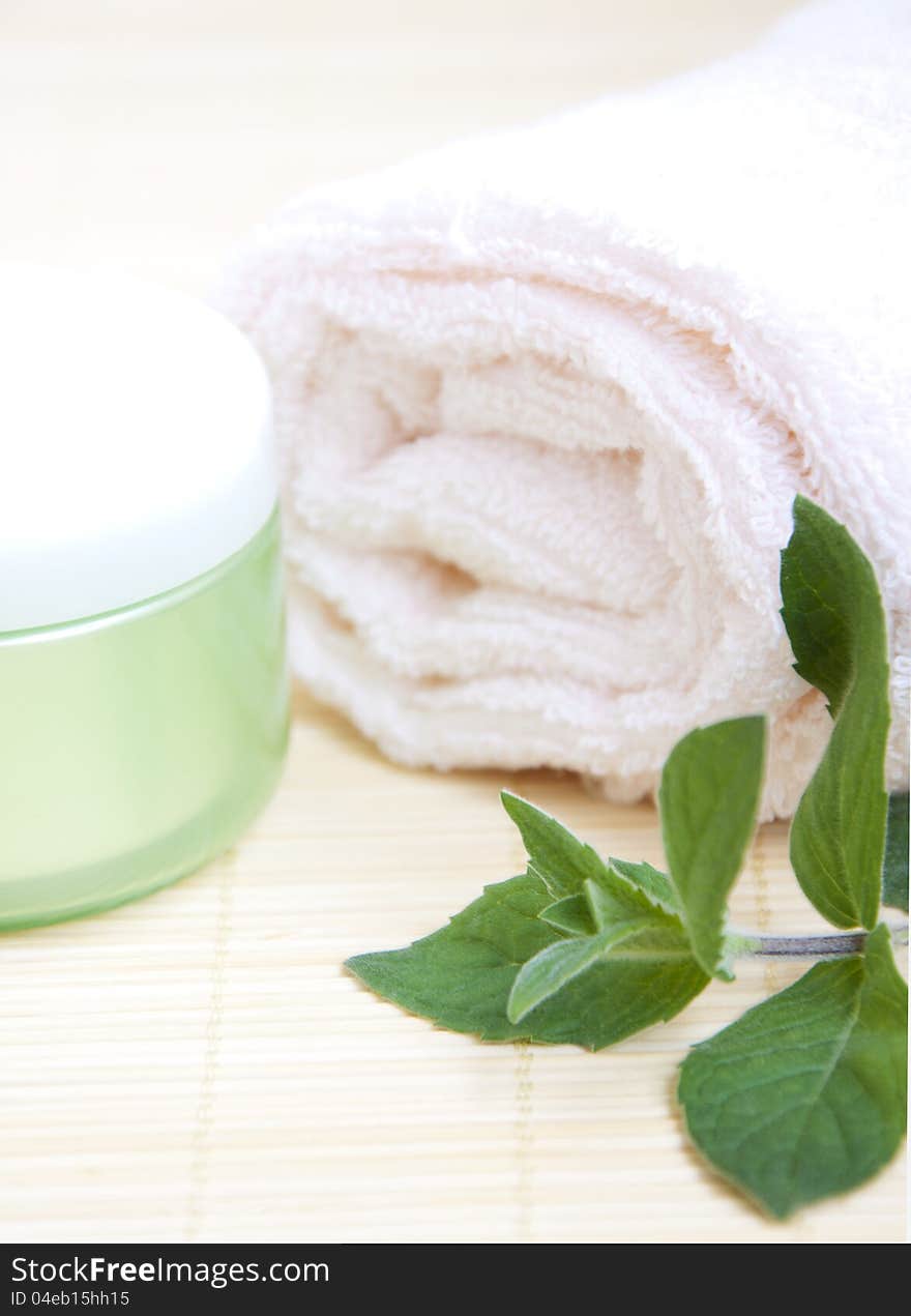 Cosmetic moisturizing cream with mint and towel. Cosmetic moisturizing cream with mint and towel