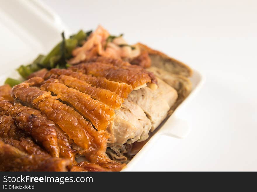 Honey roasted duck in foam box closeup