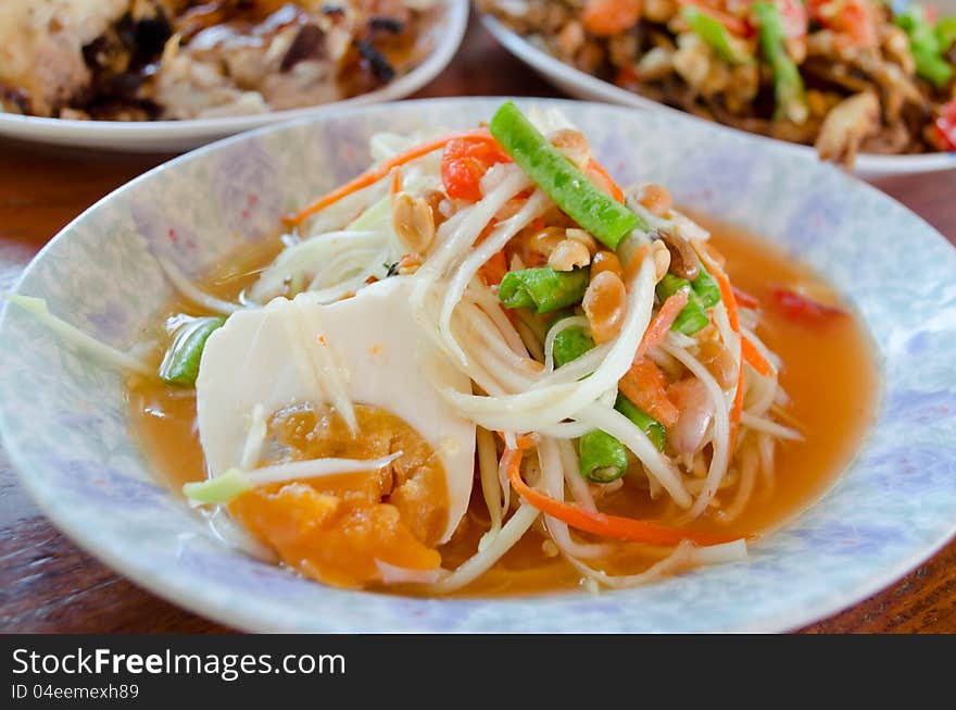 Papaya salad on table