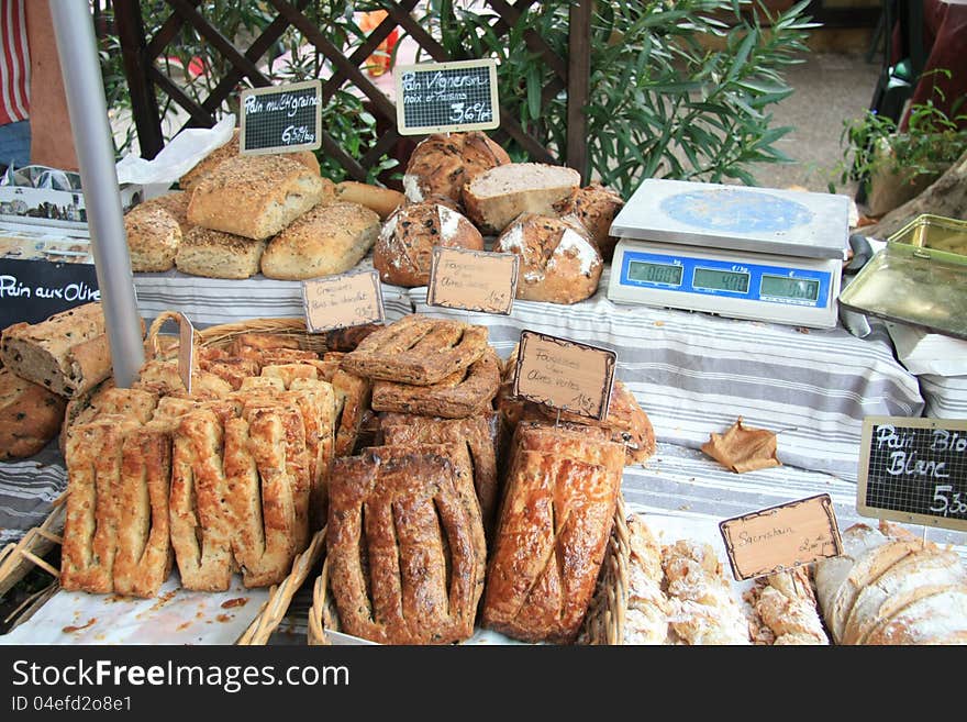 Typical French sorts of bread on a local market in the Provence, France. Typical French sorts of bread on a local market in the Provence, France