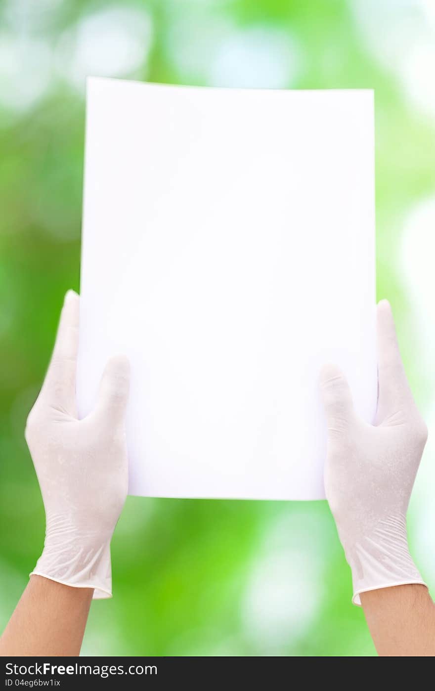 White paper in aseptic hand and green background