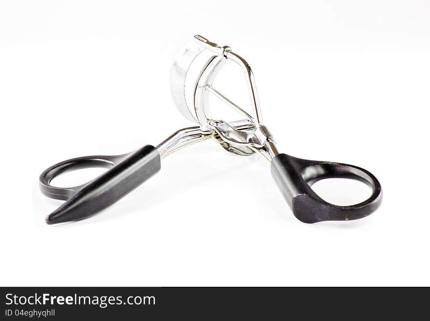 Eyelash curler on white background