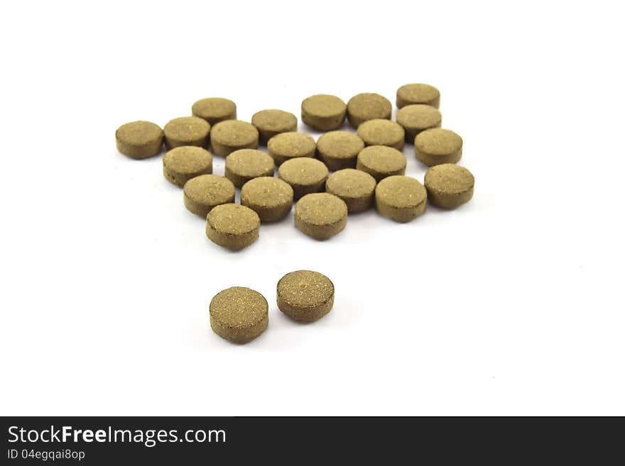 Herb pills on white background