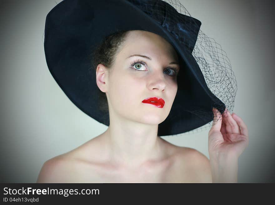 Portrait of a cute girl in retro hat with red lips