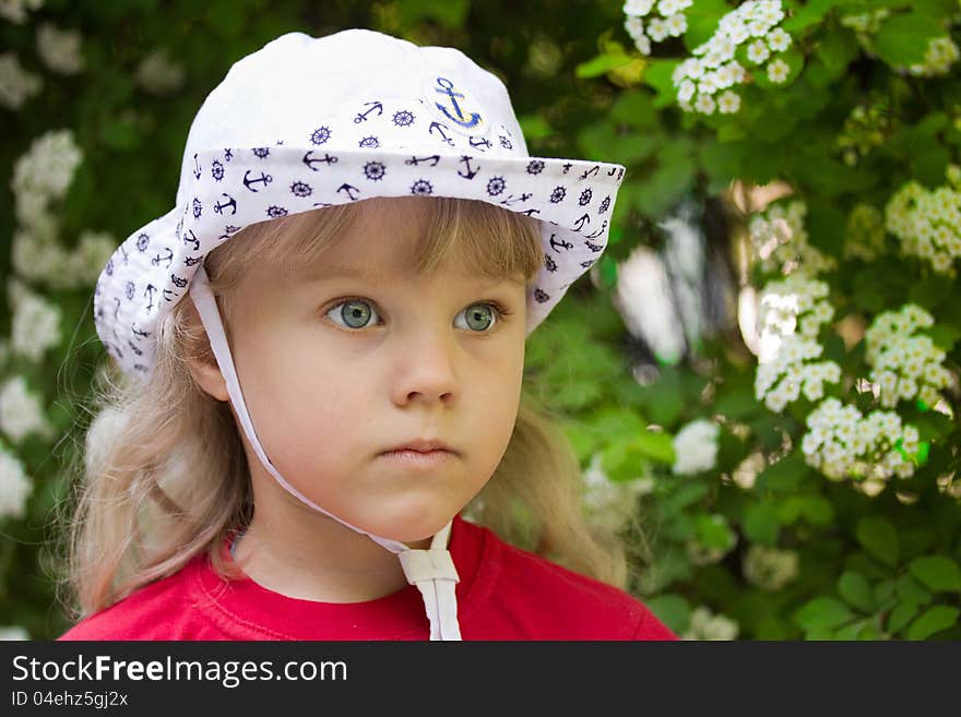 Little serious girl in a white cap. Little serious girl in a white cap