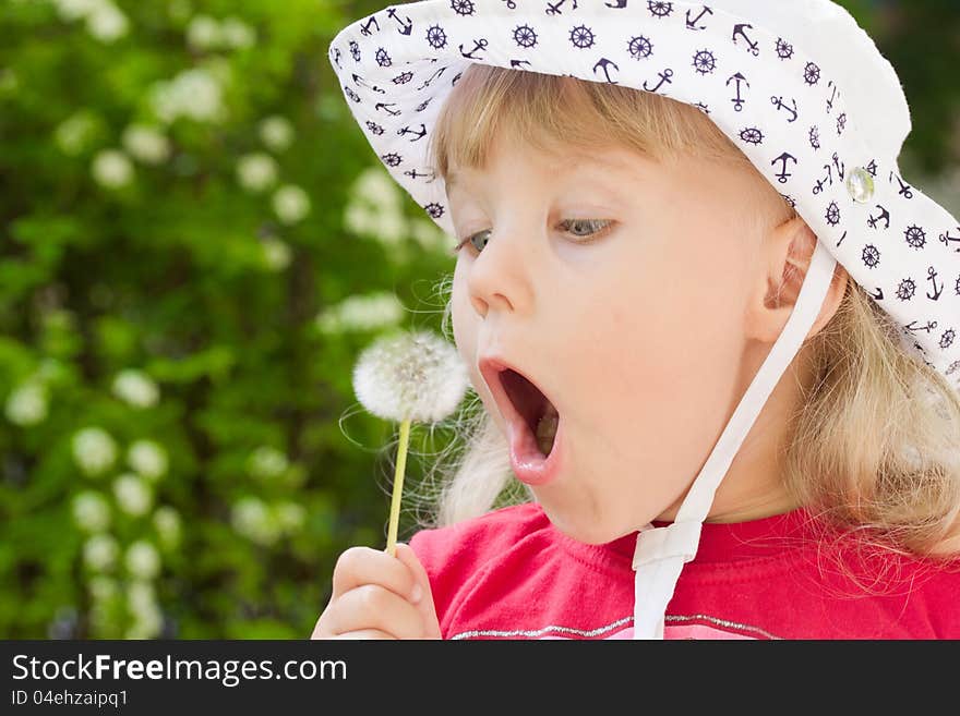 Little girl with dandelion