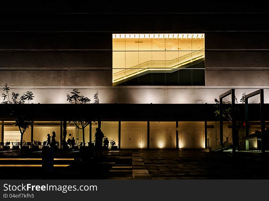 Building illuminated at night with a stairway in the windows