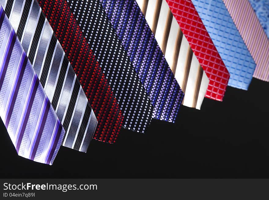 Group of colorful ties on the black background