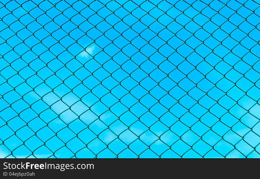 Chain fence with blue sky on the back