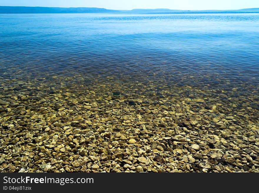 Coastline. The surface of the water with reflections. Coastline. The surface of the water with reflections