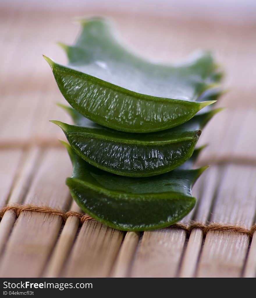 Stack of freshly sliced Aloe Vera on a wooden background