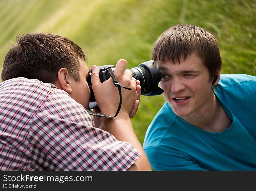 The young men looks into the camera lens. The young men looks into the camera lens