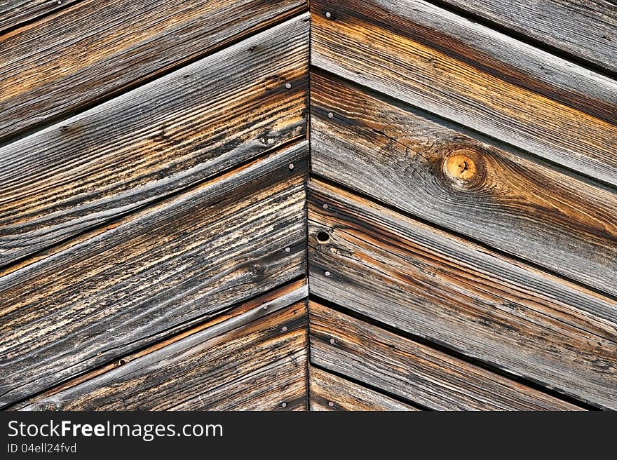 Old weather-beaten boards, element of the sheeting of the lodge