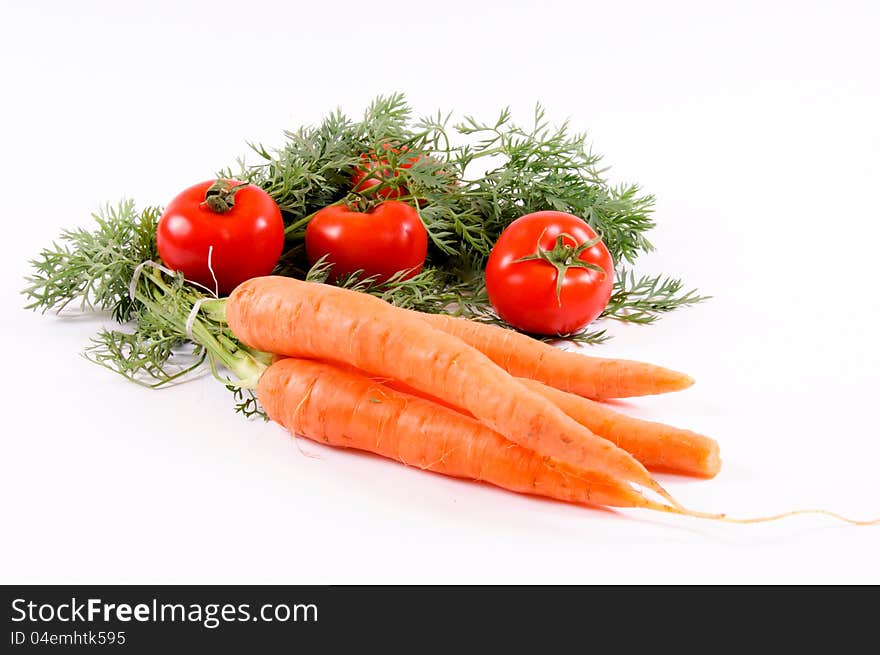 Carrots and tomatoes on white. Carrots and tomatoes on white