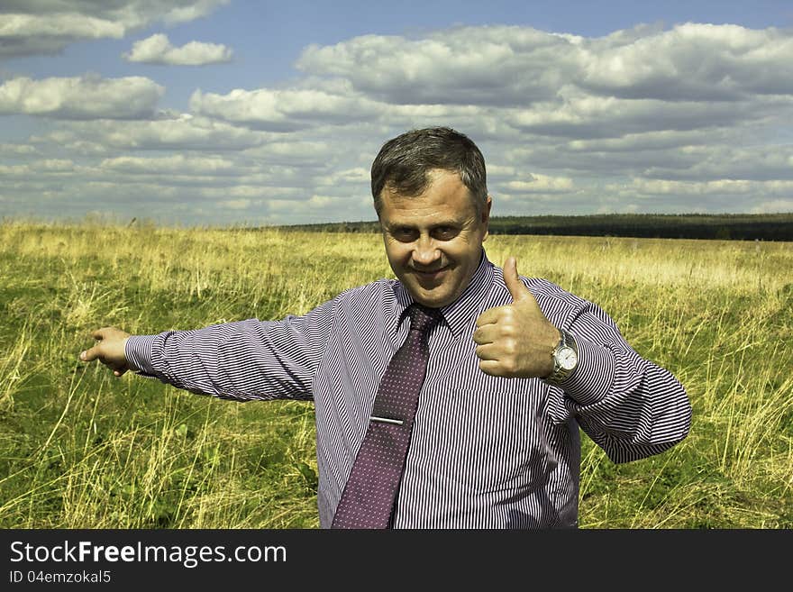 Portrait of a businessman in a shirt and tie, with a raised finger up, outdoors