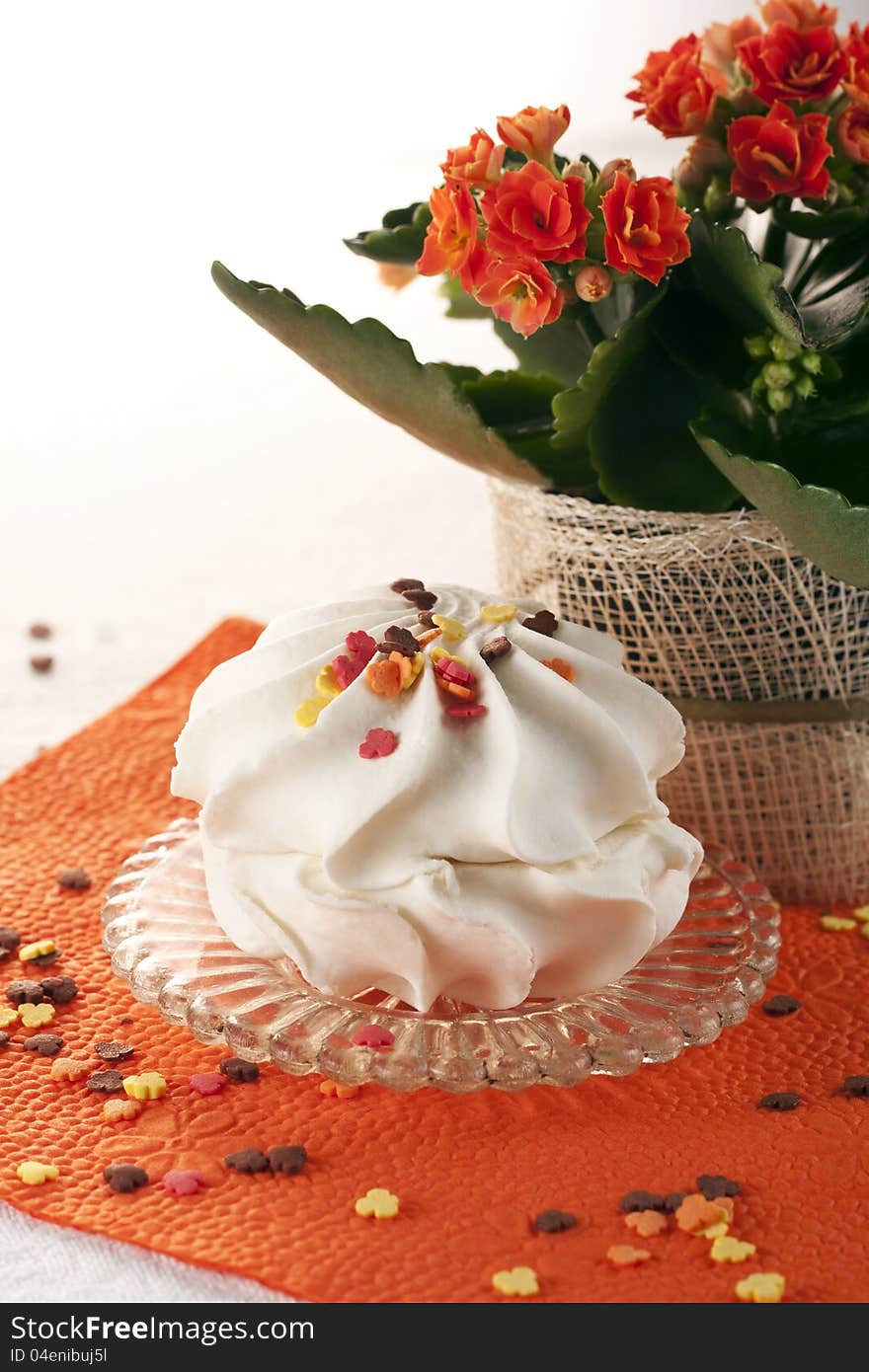 Marshmallow dessert on a red napkin with a flower in the background