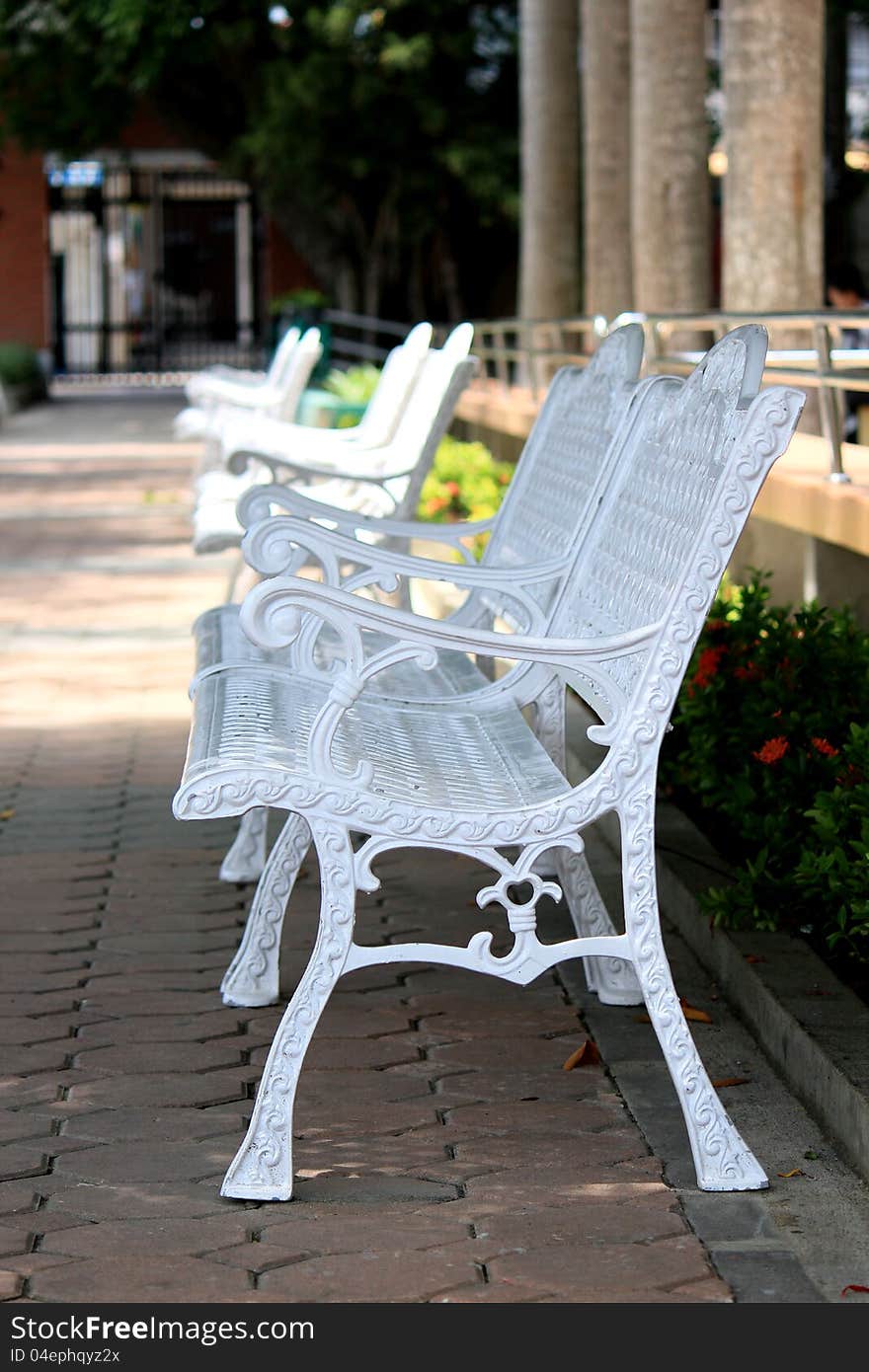 Chair in the park on during the day.