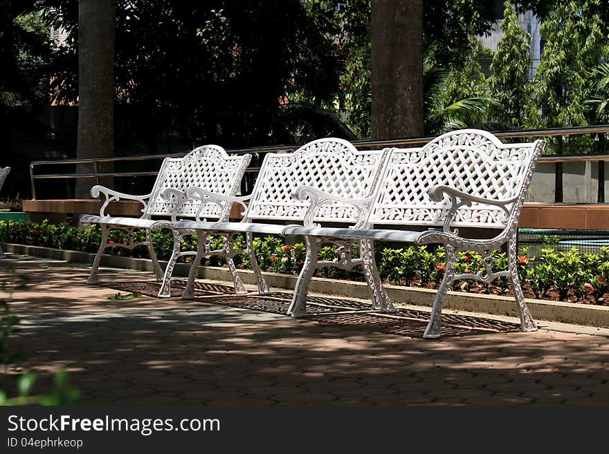 Chair in the park on during the day.