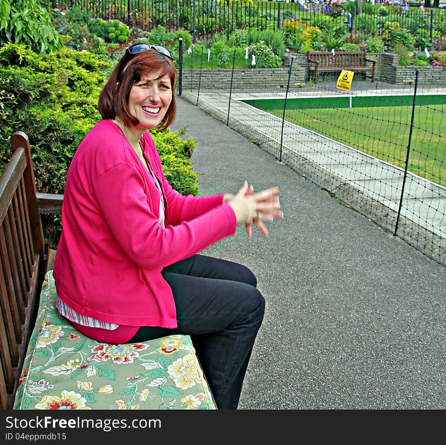 Photo of an excited woman cheering on her favourite team all dressed in pink!. Photo of an excited woman cheering on her favourite team all dressed in pink!