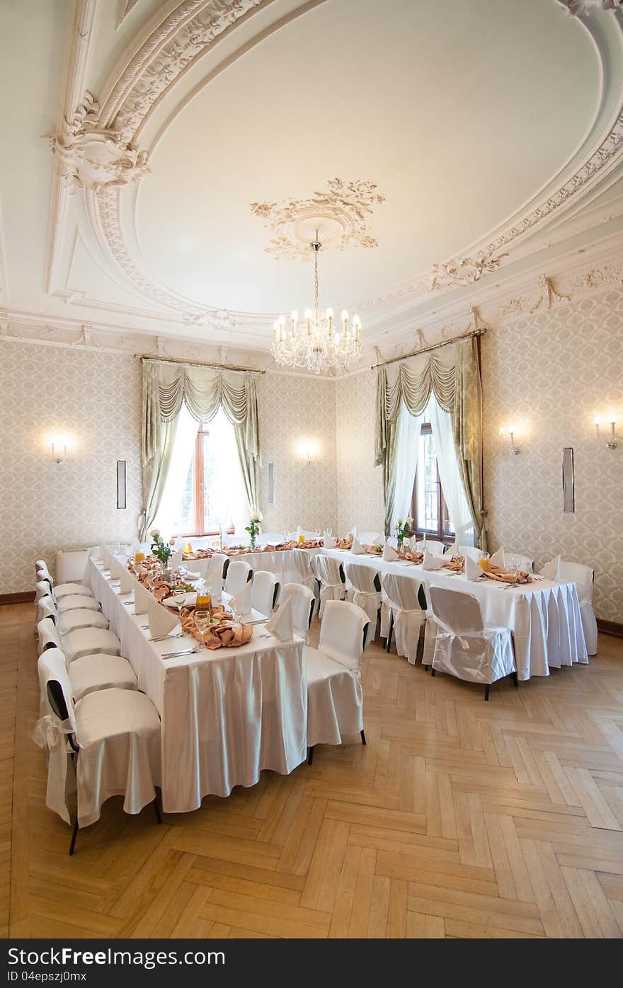 Wedding reception place ready for first guests to come. Beautiful classic white interior