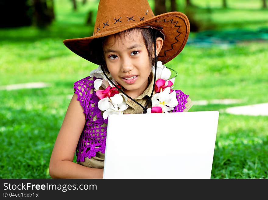 Cute asian girl living with laptop in the park. Cute asian girl living with laptop in the park