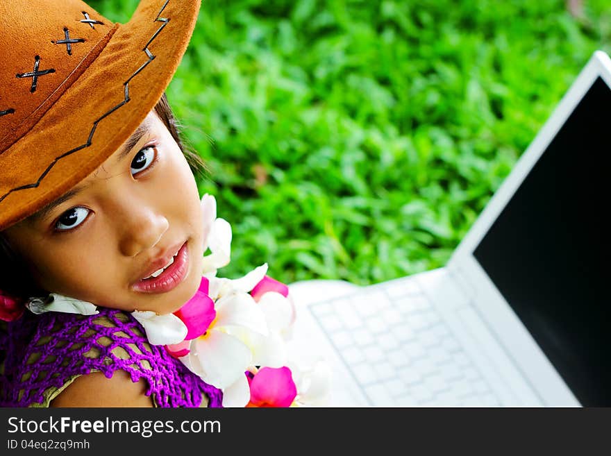 Cute asian girl wearing a cowboy hat looking at the camera. Cute asian girl wearing a cowboy hat looking at the camera