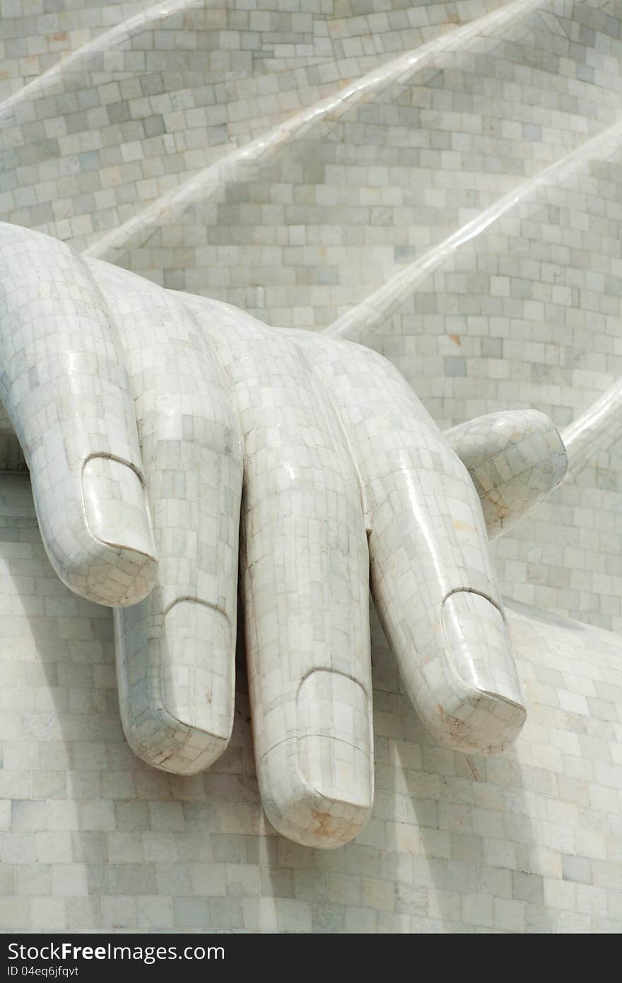 The hand of the big buddha of Phuket, Thailand. Isolated hand only against folds of the robe. The hand of the big buddha of Phuket, Thailand. Isolated hand only against folds of the robe.