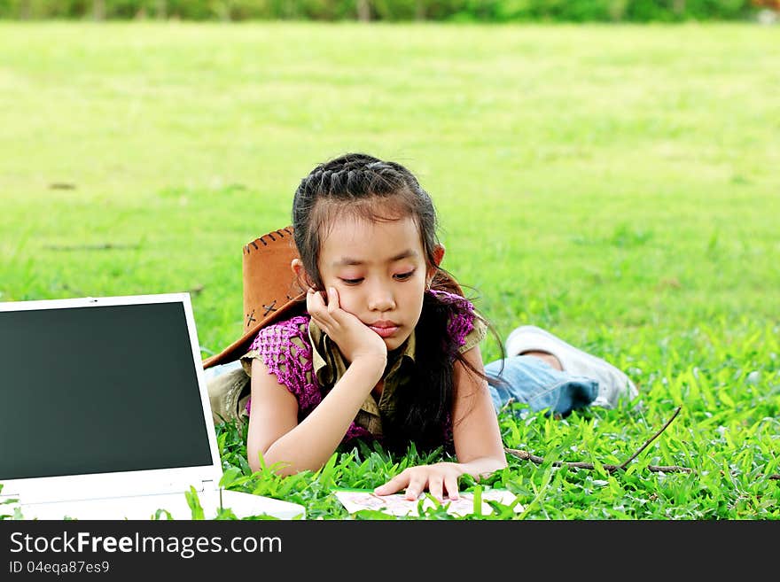 Little girl read her note on the garden. Little girl read her note on the garden