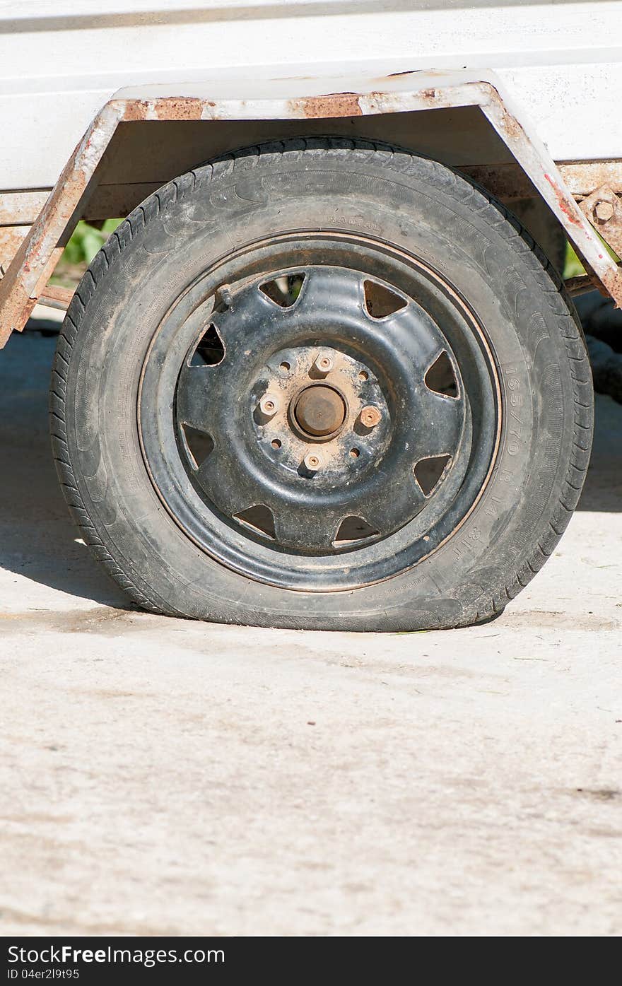 An old wheel with a flat tyre