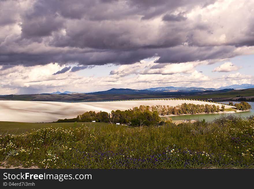 Lake ,trees and hill with cloudy sky as background. Lake ,trees and hill with cloudy sky as background