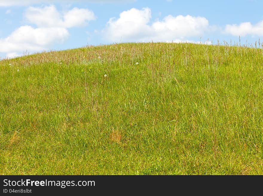 Green Hill below Blue Sky