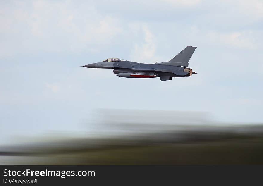 Military jet airplane at high speed with motion blur. Military jet airplane at high speed with motion blur