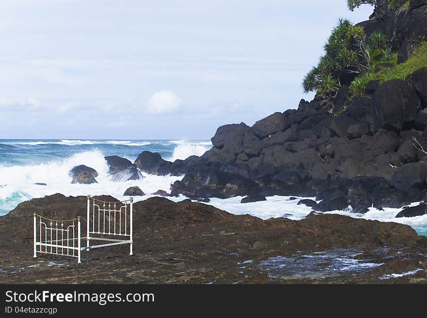 Iron bed on beach